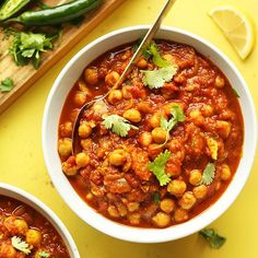 two bowls filled with chickpeas and garnished with cilantro