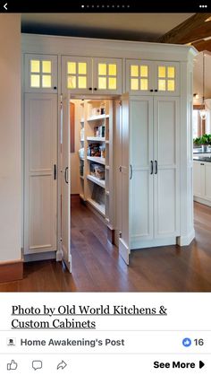 an image of a kitchen with white cabinets and wood flooring on the bottom level