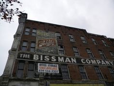 an old brick building with the words the biss man company on it's side