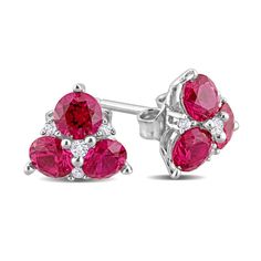 Display your playful and vibrant style with these red lab-created ruby and white lab-created sapphire flower stud earrings. Crafted in sterling silver Each earring showcases a trio of 4.0mm round bright red lab-created rubies. Dainty white lab-created sapphires dot the floral design with a touch of shimmer. These post earrings secure comfortably with friction backs. Cubic Zirconia Earrings With Accent Stones, Cluster Ruby Jewelry In White Gold, Red Cluster Jewelry With Diamond Accents, Round Cubic Zirconia Earrings With Accent Stones, White Gold Ruby Cluster Jewelry, Red Cluster Earrings For Anniversary, Red Cluster Jewelry With Prong Setting, Red Cluster Earrings With Prong Setting As Gift, White Gold Cluster Ruby Jewelry