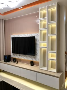 an entertainment center with built in speakers and a flat screen tv mounted on the wall