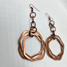 These unique vintage copper dangle earrings are the perfect touch of boho chic to any outfit, these earrings make a statement while adding a touch of elegance. Stand out from the crowd and add these must-have earrings to your collection today! Vintage Copper Dangle Details: vintage copper design 3 copper rings denim perfect great gift idea boho chic 3" drop Bohemian Dangle Hoop Earrings With Copper Wire, Handmade Copper Drop Earrings, Bohemian Bronze Metal Earrings, Vintage Metal Chandelier Earrings With Ear Wire, Unique Rust-colored Earrings With Ear Wire, Bohemian Nickel-free Rust Earrings, Vintage Copper Dangle Jewelry, Rust Bohemian Earrings For Pierced Ears, Unique Rust Earrings With Ear Wire