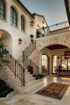 the entrance to a large home with stone steps