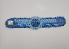 This is a handmade crochet bracelet with beads. I made it with high quality 100% Egyptian cotton thread. The center piece is a multilayered flower with beads.  I will answer any questions related to the bracelet.  There is only one bracelet available and it is ready for shipping. I can create a custom one upon request. Shipping is free. The bracelet will be shipped within 1 business day upon purchase for faster receiving! www.facebook.com/LindiBracelets www.LindiBracelets.com Instagram.com/LinDiBracelets #bracelet, #crochetbracelet, #bracelets, #crochetbracelets, #crochet, #crochetjewelry, #handmade, #handmadejewelry, #handmadebracelet, #handmadebracelets, #cuff, #cuffbracelet, #cuffbracelets, #cuffcrochet, #cuffjewelry, Blue Handmade Wearable Art Bracelet, Crochet Bracelet With Beads, Bohemian Blue Flower Bracelets, Flower With Beads, Blue Bohemian Crochet Jewelry, Bracelet Au Crochet, Adjustable Crochet Jewelry Bracelet, Bohemian Blue Evil Eye Bracelet Hand-strung, Blue Sunflower