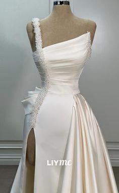 a white wedding dress on display in front of a mannequin