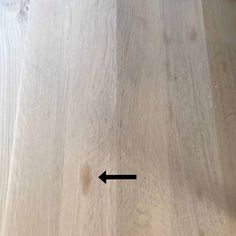 a wooden floor with an arrow pointing to the left and right side of the wood