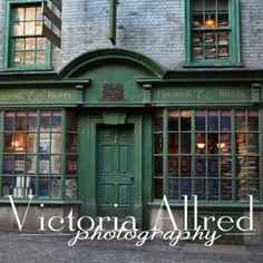 an old brick building with green doors and windows on the outside, in front of it is a sign that reads victoria allred photography