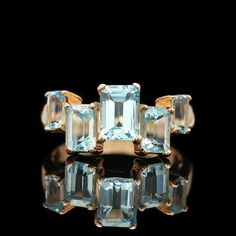 A 14k yellow gold emerald cut 5-stone blue topaz ring with offset, graduating gemstones. SR2078 Weight: 4.00 grams (Inclusive of all materials) Ring Size: 7.5 Blue Topaz (5) Emerald Cut Stone Measurements: 5.06 x 3.53 - 7.28 x 5.75 Engraved Cross, Starburst Necklace, Amber Ring, Gold Engraving, Cabochon Ring, Onyx Ring, Yellow Gold Earring, Green Tourmaline, Blue Topaz Ring