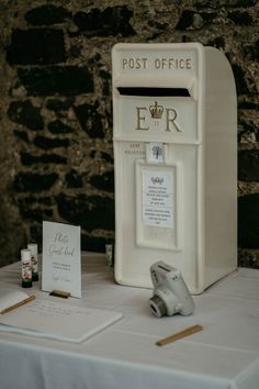 a white post box sitting on top of a table