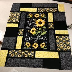 a sunflower quilt with the words you are my sunshine written on it in black and yellow