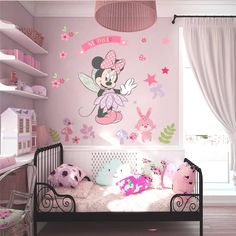 a child's bedroom decorated in pink and white with minnie mouse wall decals