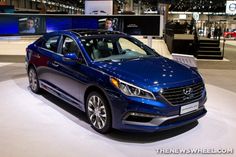 a blue car is on display at an auto show