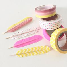 washi tape and feathers on a white surface