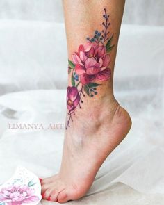 a close up of a person's foot with flowers on it