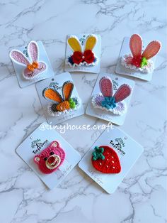 six crocheted strawberry hair clips on top of a marble counter with text overlay