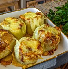 baked stuffed cabbages in a baking dish with parsley