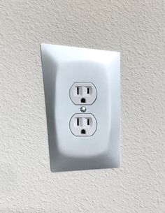 an electrical outlet with two outlets on the wall