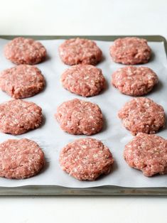 raw hamburger patties on a baking sheet ready to be baked