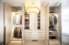 a walk in closet filled with lots of clothes