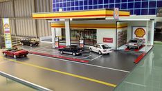 a model gas station with cars on the road