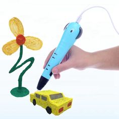 a hand holding a pen and drawing a flower next to a toy car with a pencil in it