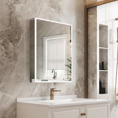 a bathroom with marble walls and white cabinets