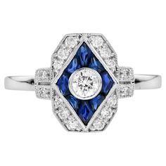 a diamond and blue sapphire ring with diamonds on the sides, set in white gold