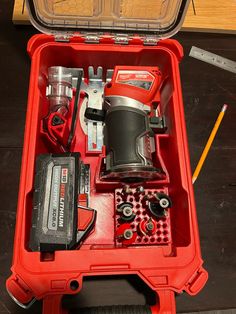 a red tool box filled with tools on top of a table