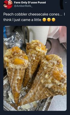 three ice cream cones with toppings sitting on top of tin foil in front of a cup