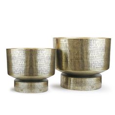 two metal bowls sitting on top of each other