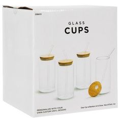 three glass cups with lids and straws in front of a white box on a white background