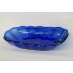 a blue glass bowl sitting on top of a table