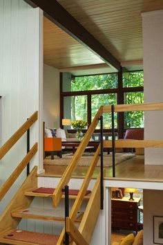 the stairs are made of wood and have handrails that lead up to the second floor