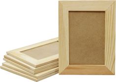 a set of four unfinished wooden frames with one missing the front and side, sitting next to each other