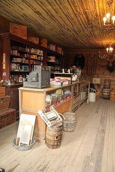 an old fashioned bar with wooden floors and walls