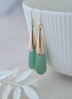 Pale green jade teardrop earrings that are elegant and chic.   The jade tear drops have a shiny gold plated cone bead cap and gold plated french earring wires. Simple and lovely. The earrings hang approximately 2.25in length. As this is a natural stone, there will be dark green or light green jade.  I will always match the two earrings, but the colour may differ from the picture.  Please understand that I cannot take a picture for every shade of green that I have.  If you want a specific shade t Teardrop Jade Earrings For Formal Occasions, Elegant Jade Teardrop Earrings, Elegant Teardrop Jade Earrings, Elegant Green Long Drop Earrings, Elegant Green Teardrop Pendant Earrings, Elegant Teardrop Earrings For May Birthstone, Green Jade Earrings For Wedding, Elegant Green Teardrop Earrings, Elegant Green Teardrop Earrings For Anniversary