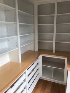 empty white shelves and drawers in a room