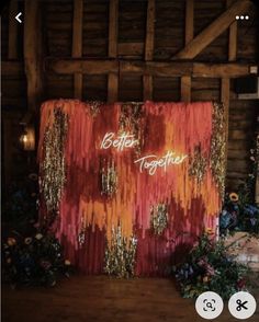 a red and gold backdrop with the words better together on it in front of some flowers