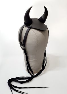 Make a statement in this harness fascinator headpiece with curved demon or devil horns. Base of horns is wrapped in gauze. Attaches to the hair with a comb and gauze tiesthat can be tied in the back of the head or under the chin. Shown in black vegan leather. Black matte metal hardware. One size. All pieces are MADE TO ORDER Please contact us if you have any questions or requests about sizing! Every piece is made by hand in Seattle, WA. Please check the notification bar at the top of the page fo Devil Horns, Back Of The Head, Black Vegan, Black Matte, Metal Hardware, Make Time, Fascinator, 3 Weeks, Ruler