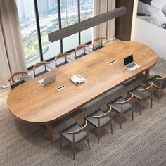 a conference table with chairs and laptops on it in front of a large window