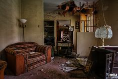 an old living room with broken furniture in it