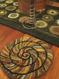 a rug on the floor next to a chair with a foot rest in front of it