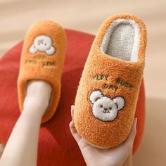 The Busy Day Slippers are the perfect slippers for a productive day indoors. Whether you are working from home or doing housework, these slippers will keep you comfortable during your busy day. They are plush throughout and have a cute smiling bear and text on the top of each slipper. Walk-in style with The Busy Day Slippers! FEATURES: Style Closed Toe Season Spring/Summer/Winter/Fall Sole Flat Vamp material Cotton Fabric COMFORTABLE MATERIAL: The Busy Day Slippers are made of high-density mater Orange Flat Synthetic Slippers, Comfy Round Toe Slippers For Home, Comfy Non-slip Flat Slippers, Non-slip Flat Slippers For Indoor Use, Non-slip Flat Indoor Slippers, Comfortable Flat Slippers For Home, Comfortable Non-slip Home Slippers, Casual Non-slip Slippers For Home, Casual Non-slip Slippers