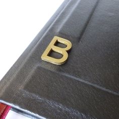 a close up of a book with the letter b on it's front cover