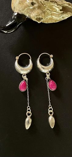 **Elevate your look with a touch of sophistication and elegance with our sterling silver small hoop earrings featuring a drop Ruby dangle. The vibrant red Ruby gemstone adds a pop of color and a hint of glamour to the classic hoop design. Crafted from high-quality sterling silver, these earrings are perfect for adding a touch of luxury to your everyday look or for complementing a special occasion outfit. The small size of the hoops makes them versatile and suitable for any occasion, while the Ruby gemstone adds a touch of timeless beauty. Treat yourself or someone special to these exquisite earrings. Sterling Silver Drop Hoop Earring, Sterling Silver Single Drop Hoop Earring, Sterling Silver Teardrop Cartilage Earrings, Silver Sterling Huggie Earrings With Dangling Charms, Silver Teardrop Earrings With Dangling Charms, Occasion Outfit, Chunky Hoop Earrings, Small Hoop Earrings, Hoop Design