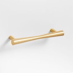 a gold colored handle on a white wall