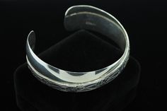 "One Renee Lupre ((c) ca. 1980), Sterling Silver, Floral Cuff Bracelet. The bracelet measures 13.2mm in the middle of the bracelet and 18.5mm+ at the ends. The bracelet measures 6 1/8\" on the exterior with a 1\" gap. All the appropriate hallmarks are present and total weight is 36.80 grams. Most items purchased before 2pm EST will be shipped same day using USPS First Class Mail (\"2-3day\") and will be insured, requiring signature upon delivery. In the event that key employees are on a buying t Elegant Wide Band Stamped Jewelry, Formal Cuff Bracelet, Elegant Stamped Bangle For Formal Occasions, Formal Wide Band Adjustable Bangle, Formal Adjustable Wide Band Bangle, Elegant Stamped Cuff Bracelet In Bangle Style, Formal Adjustable Stamped Bangle, Elegant Stamped Bracelet For Formal Occasions, Elegant Stamped Cuff Bracelet Bangle