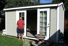 a man standing in front of a shed