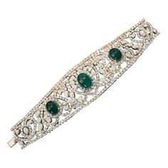 Diamond and Emerald Bracelet in 18k White Gold Features Three Cabochon Emeralds weighing a total of 20.00 carats estimated set with Round Brilliant Diamonds in Heart and Paisley design 30.00 carats in total of Diamonds Total Stone weight is 50.00 carats estimated Bracelet measures 7 inches long and 1.60 inches wide and weighs 101.4 grams Marked Chaar, 750 BUY WITH CONFIDENCE Authenticity is guaranteed for every item we sell. Elegant Cabochon Bracelets For Anniversary, Luxury Diamond Jewelry With Cabochon Cut, Luxury Cabochon Diamond Jewelry, Luxury Cabochon Bangle Jewelry, Luxury Wedding Bracelet With Cabochon, Luxury Cabochon Bracelets For Wedding, Elegant Formal Cabochon Bracelets, Elegant Cabochon Bracelet Jewelry, Luxury Silver Bracelets With Cabochon