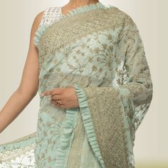 Feel beautiful and special in this stunning green IIndian Saree Dress in Georgette - the perfect pick for a special occasion. With a flirty frill that curves along the entire edge, this graceful saree is sure to turn heads! Thanks to its vibrant color and intricate embroidery, this saree captures a unique blend of contemporary style with timeless Indian elements. The bold silver accent shines against the green background, creating an elegant yet stylish look. Whether you want to add some glamour Green Sharara With Ruffles And Traditional Drape, Green Ruffled Sharara With Traditional Drape, Pre-draped Ruffled Saree For Diwali, Diwali Anarkali Traditional Wear With Ruffles, Diwali Anarkali With Ruffles, Anarkali Saree With Ruffles In Traditional Drape, Designer Semi-stitched Ruffled Blouse Piece, Green Organza Dress With Cutdana, Green Organza Dress With Cutdana Detailing